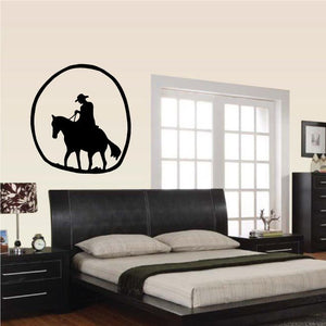 Cowboy silhouette wall decal of a rider on a horse inside a bold oval outline