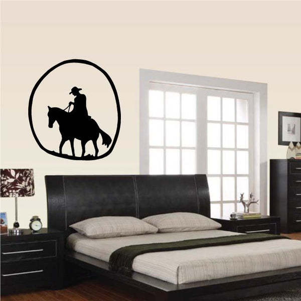 Cowboy silhouette wall decal of a rider on a horse inside a bold oval outline