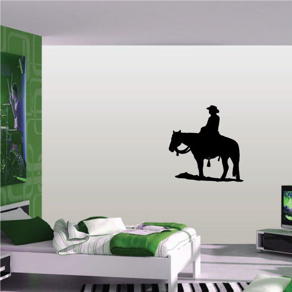 Cowboy wall decal of black cowboy riding horse silhouette