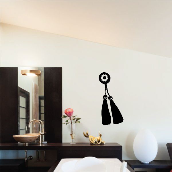 Cowboy boot wall decal with two hanging black boots and a circular gear ornament