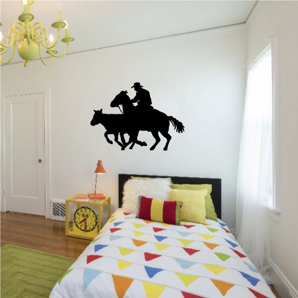 Cowboy on horseback vinyl wall decal, black silhouette.