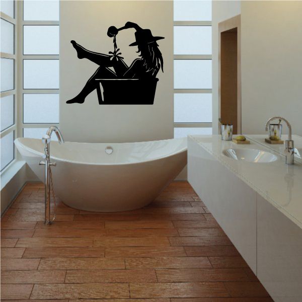 Cowgirl wall decal: black vinyl silhouette of rider on horse with hat and lasso