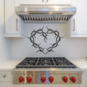 Black crown-of-thorns heart decal with outlined thorn rays on smooth surface