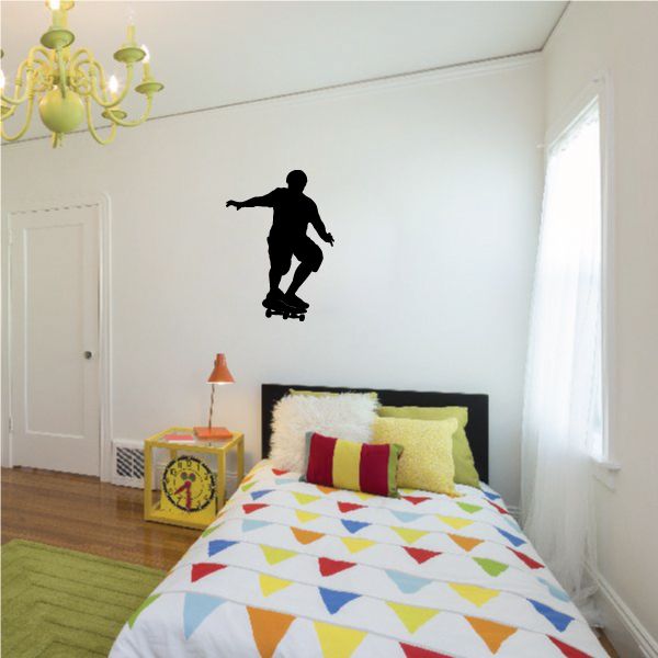 Black skateboarder silhouette wall decal, skateboarding figure on board.