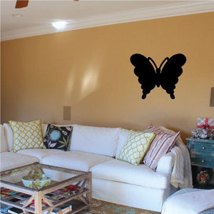 Butterfly wall decal with black silhouette and small gold accents