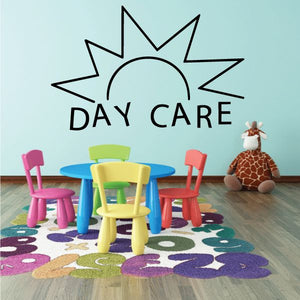 Vinyl wall decal of sunburst with “DAY CARE” lettering in black