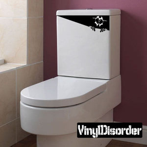 Toilet lid decal with black bat-like monster and claw marks