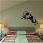 Jumping Rottweiler decal with black-and-tan dog midair on a wall