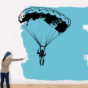 Parachuting decal with teal canopy and black diver silhouette with parachute ropes
