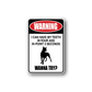 Rectangular sticker with rounded border, red WARNING oval and black dog silhouette text