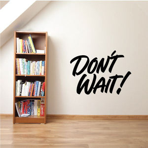 Black script wall decal reading “DON'T WAIT!”
