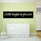 Wall decal: black banner with 'Earth laughs in flowers' text