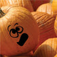 Pumpkin face decal with black cartoon expression on orange pumpkin