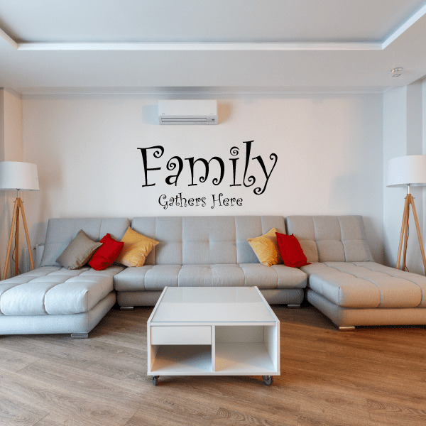 Wall decal with 'Family' and 'Gathers Here' in curly black script