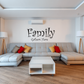 Wall decal with 'Family' and 'Gathers Here' in curly black script