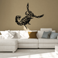 Black scorpion decal with detailed skeleton-style design on wall above sofa