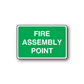 Green fire assembly point sign sticker with white text in rounded rectangle