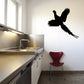 Flying quail decal with black flying bird silhouette on light wall