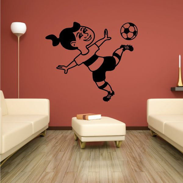 Soccer girl wall decal showing a girl kicking a ball, black vinyl silhouette