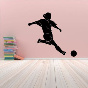 Girl soccer player silhouette wall decal, black graphic with kicking pose and ball.