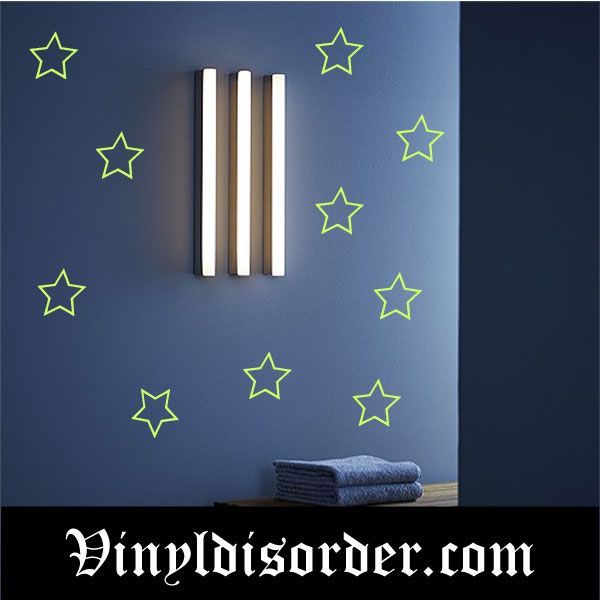 Glow-in-the-dark star decal set with outlined green stars on wall
