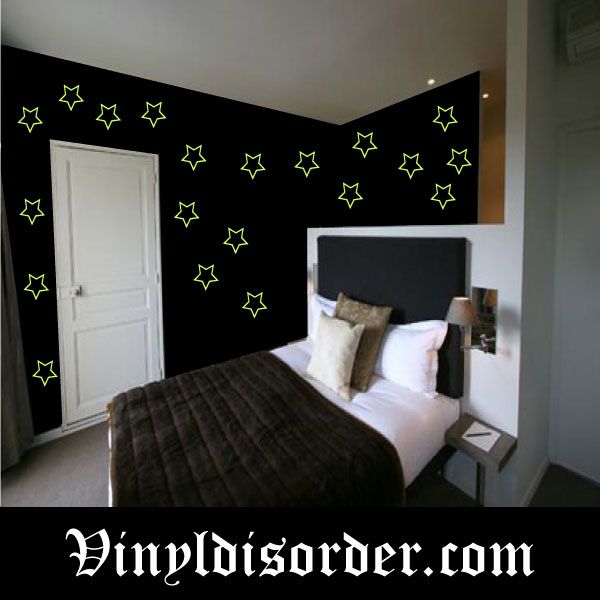 Glow-in-the-dark star wall decals, scattered outline stars on dark wall