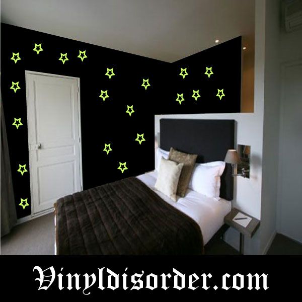 Glow in the dark star wall decals: green outlined stars on a dark wall corner