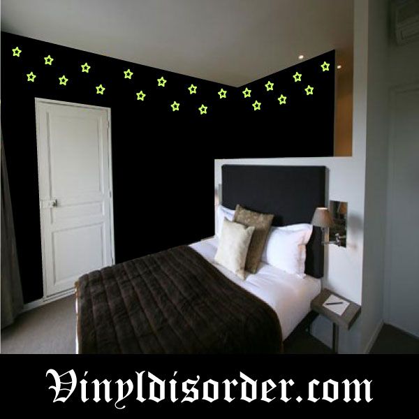Glow-in-the-dark star wall decals with small green stars scattered across black wall