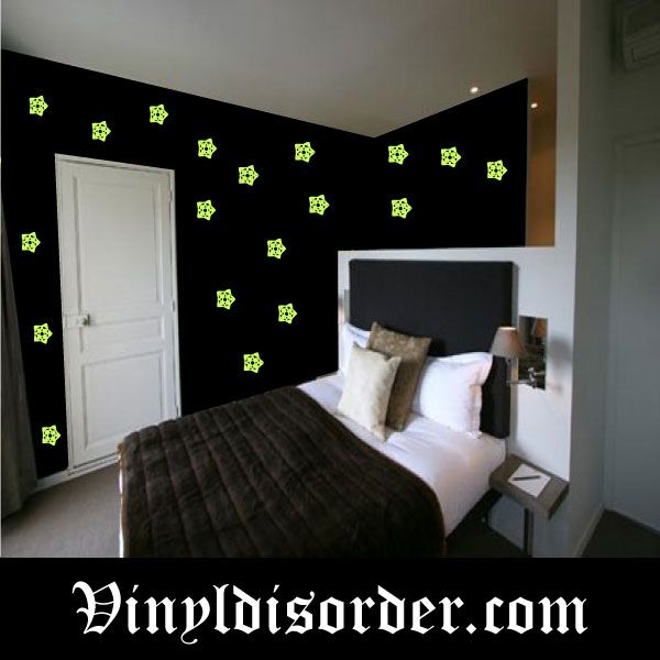 Glow-in-the-dark star wall decals, multiple small star shapes in neon green.