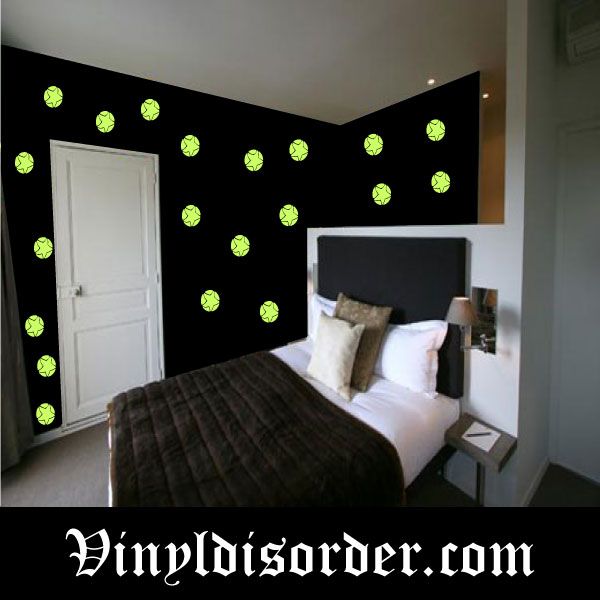 Glow-in-the-dark star wall decals with green star stickers on a dark wall