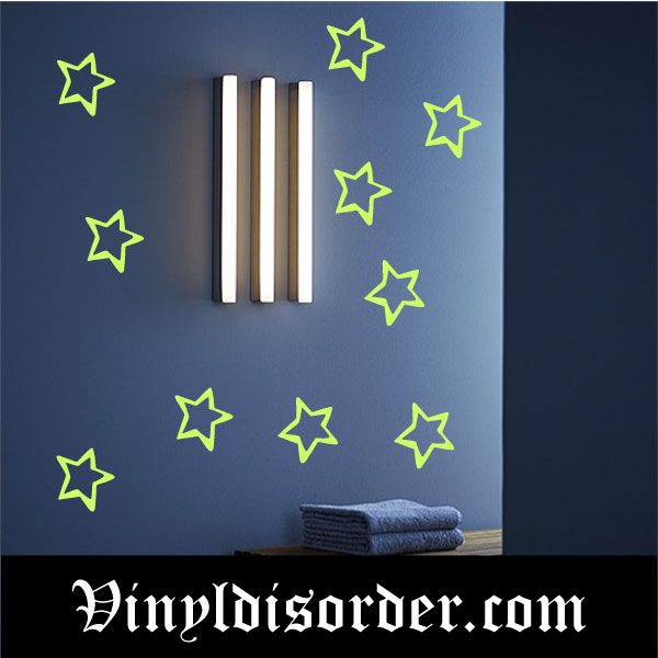 Glow-in-the-dark star wall decals with green outline stars on a dark wall