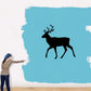 Black walking reindeer wall decal silhouette on blue