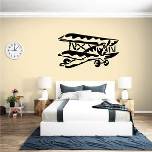 Black flying biplane graphic wall decal with wings and propeller detail.