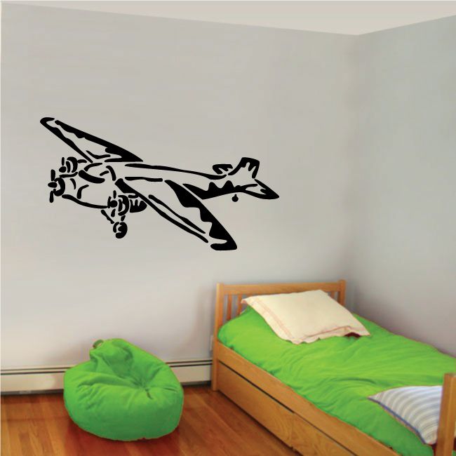 Black surveillance plane graphic decal in flight on a wall