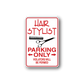 Red and white parking sign with hair stylist text, scissors and comb graphic
