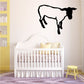 Standing sheep wall decal with black silhouette, arched legs and head turned right
