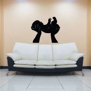 Black silhouette hands holding baby decal