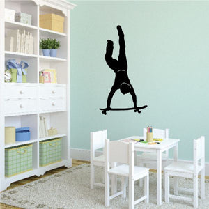 Skateboarding handstand wall decal with black silhouette on wall