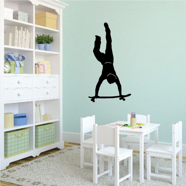 Skateboarding handstand wall decal with black silhouette on wall