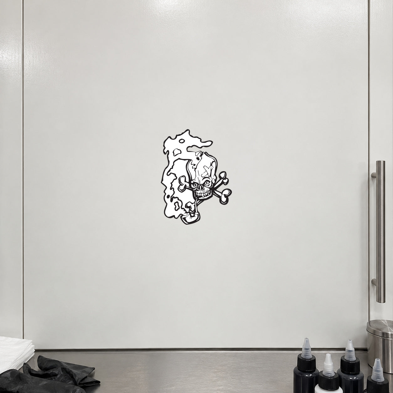 White vinyl wall decal of a skull with swirling smoke design