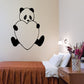 Panda face wall decal with black ears and heart-shaped body, white center