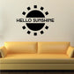 Black sunburst wall decal with 'HELLO SUNSHINE' lettering