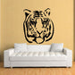 Tiger head decal with black line-art face on a light wall