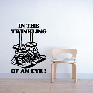 Decorative wall decal: bold 'IN THE TWINKLING OF AN EYE' text with eye graphic