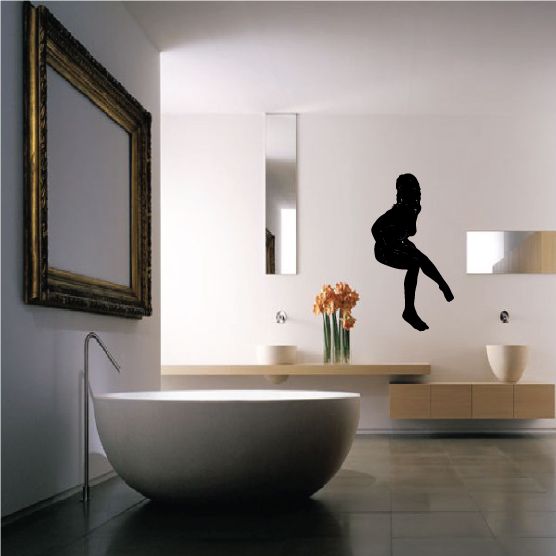 Black silhouette decal of a nude woman sitting