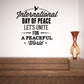 Wall decal with peace-themed lettering and dove icon in black