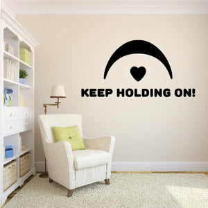 Wall decal with arched heart and bold text, “KEEP HOLDING ON!”