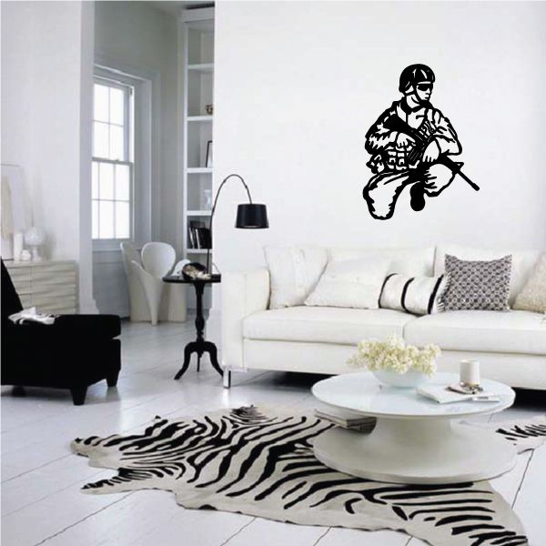 Kneeling soldier wall decal, black silhouette on light wall.