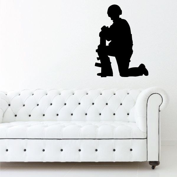 Black kneeling soldier with gun decal silhouette on white couch