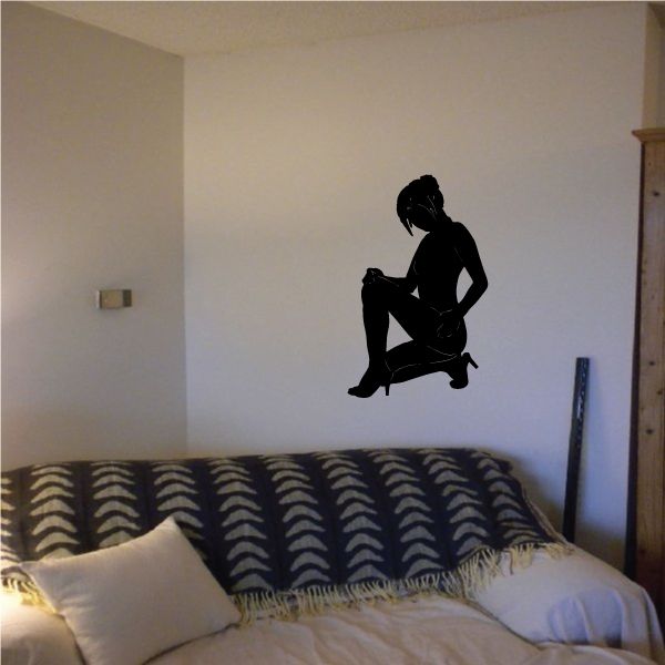 Black silhouette decal of kneeling woman in high heels